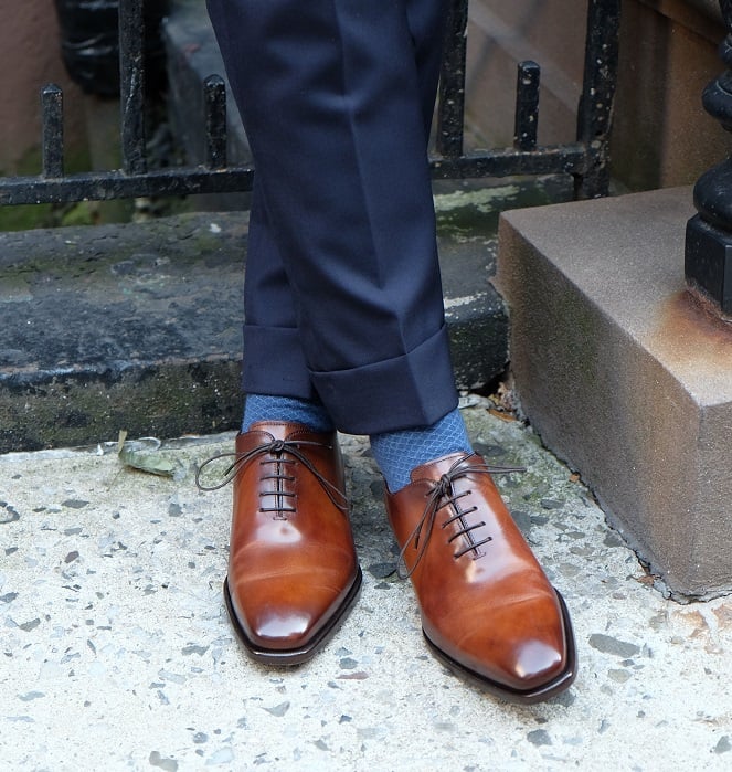 brown shoes with a navy suit